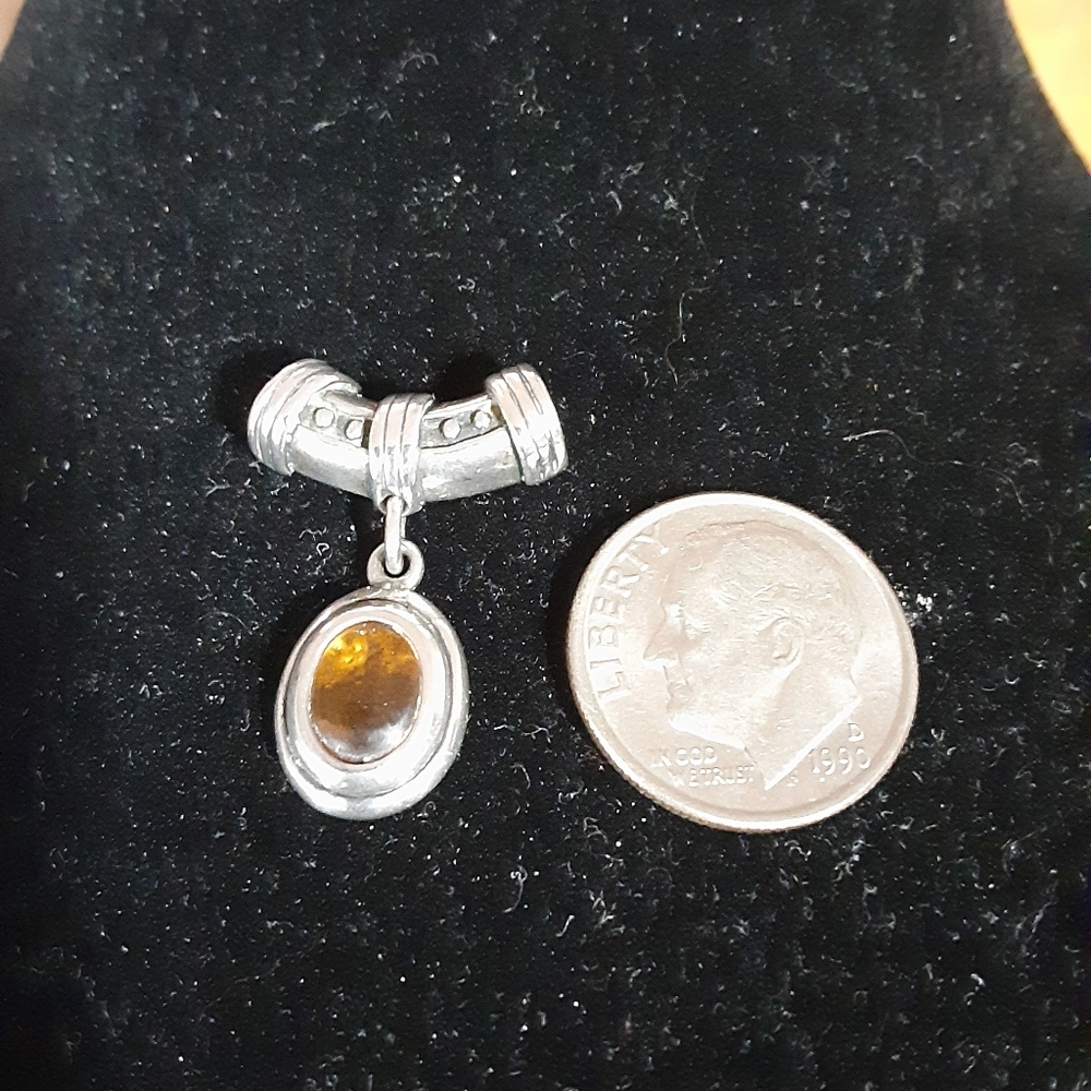 Sterling silver pendant with amber stone.  Cute!